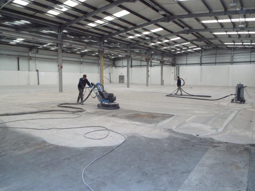 Grinding concrete deals floor for drainage