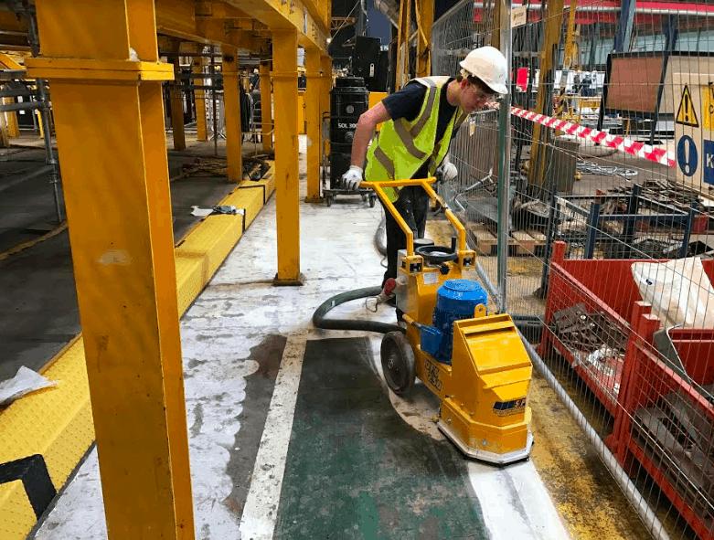 Man with Floor preparation machine