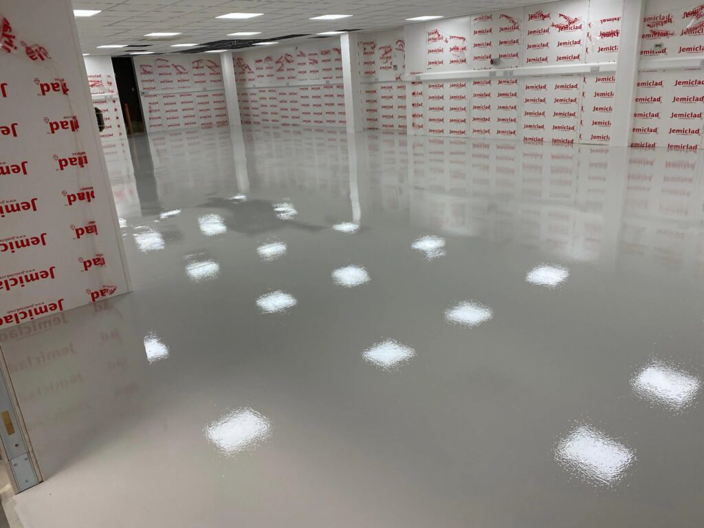 epoxy flooring installer completed work - plain white shiny floor